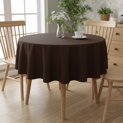 Chocolate brown Square tablecloth on a small kitchen table with turned wooden legs in a bright cosy UK home setting with flowers and tea