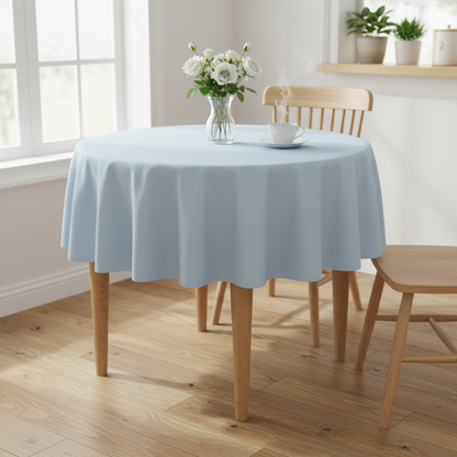 Baby blue Square tablecloth on a small kitchen table with turned wooden legs in a bright cosy UK home setting with flowers and tea