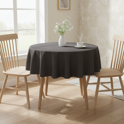 Dark grey Square tablecloth on a small kitchen table with turned wooden legs in a bright cosy UK home setting with flowers and tea