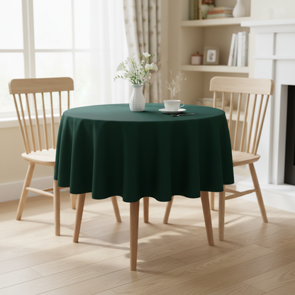 Bottle green Square tablecloth on a small kitchen table with turned wooden legs in a bright cosy UK home setting with flowers and tea