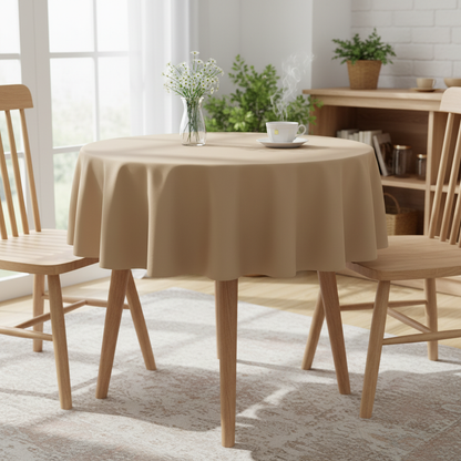 Camel Square tablecloth on a small kitchen table with turned wooden legs in a bright cosy UK home setting with flowers and tea
